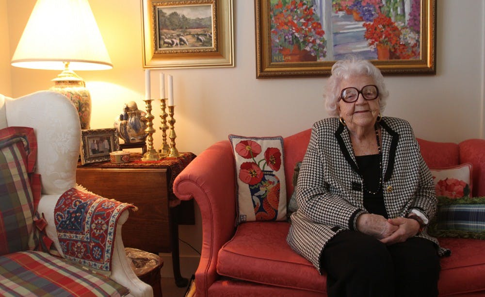 Maggie Love, 88, paints "happy paintings" that are now on display at University Mall. She has macular degeneration and is starting to lose her eyesight, which makes painting more difficult. She continues to paint and now does more abstract work. Love poses with her artwork in her home at Galloway Ridge retirement community at Fearrington. 