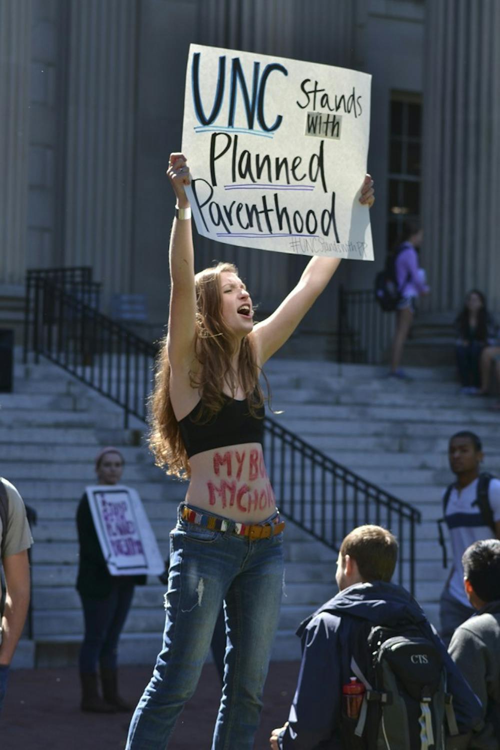 Rachel Allen, a sophomore at UNC, grabs the attention of passersby to encourage the discussion of Planned Parenthood.