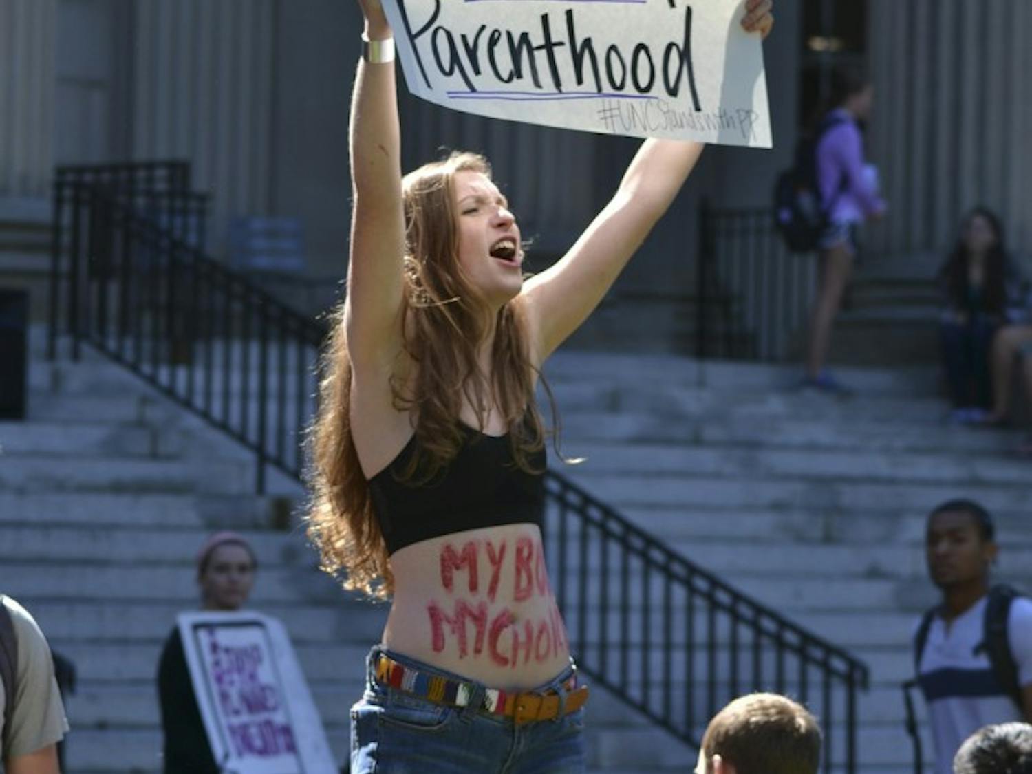 Rachel Allen, a sophomore at UNC, grabs the attention of passersby to encourage the discussion of Planned Parenthood.