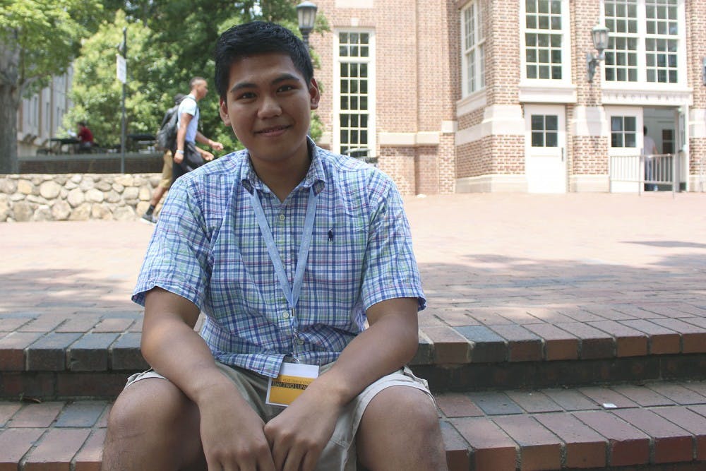 Lawrence Bacudio, a NCSSM graduate and future freshman at UNC, attends orientation despite financial issues as he awaits his green card.