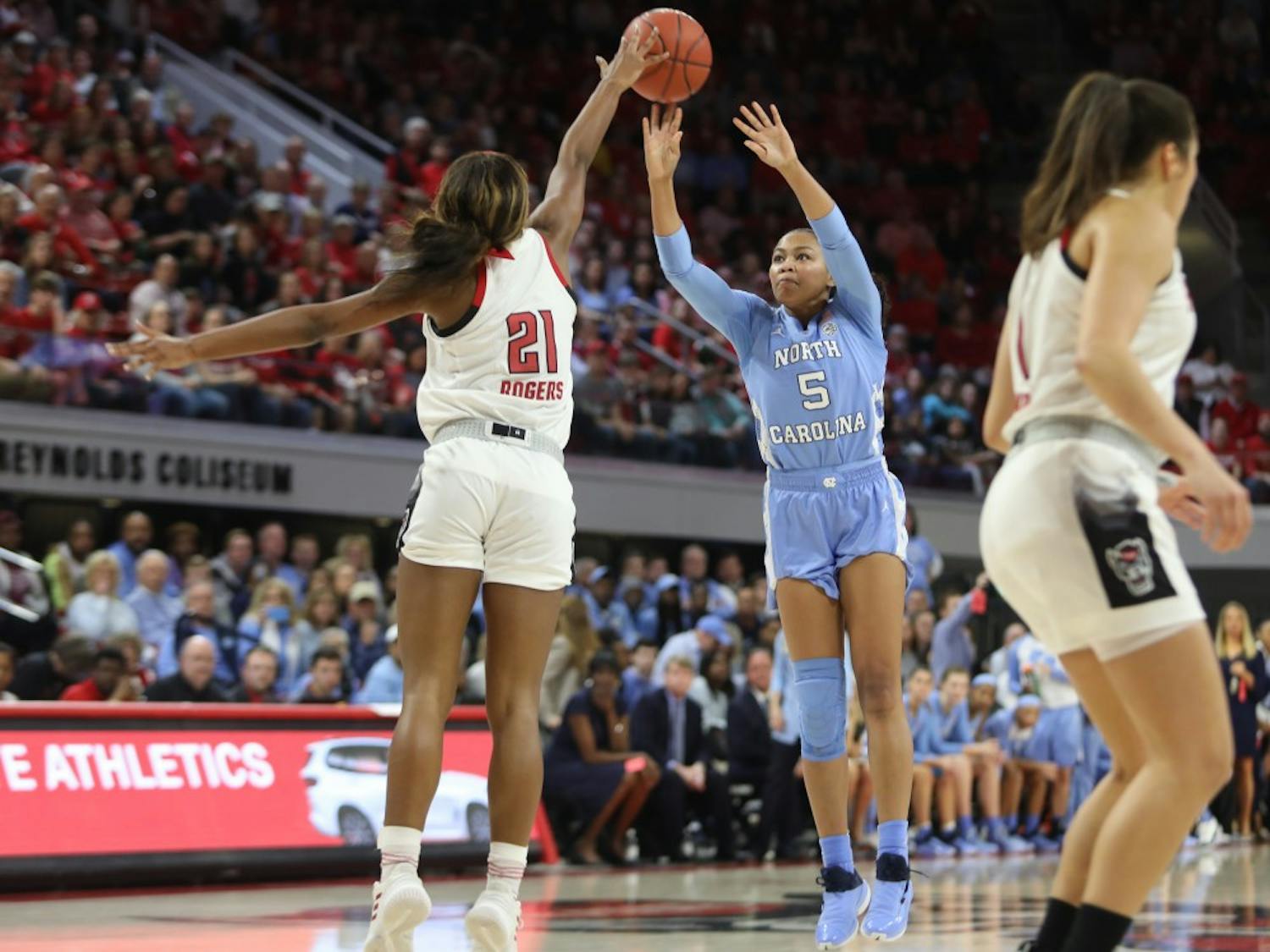 Tar Heel redshirt junior guard Stephanie Watts (5) attempts a shot against Wolfpack Senior Forward DD Rogers (22) during the UNC's 64-51 win against NC State at Reynolds Coliseum on Sunday, Feb. 3, 2019 in Raleigh, NC. The Tar Heels Women's Basketball Team (14-9) handed the Wolfpack (21-1) their first loss of the season.