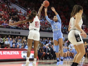 Tar Heel redshirt junior guard Stephanie Watts (5) attempts a shot against Wolfpack Senior Forward DD Rogers (22) during the UNC's 64-51 win against NC State at Reynolds Coliseum on Sunday, Feb. 3, 2019 in Raleigh, NC. The Tar Heels Women's Basketball Team (14-9) handed the Wolfpack (21-1) their first loss of the season.