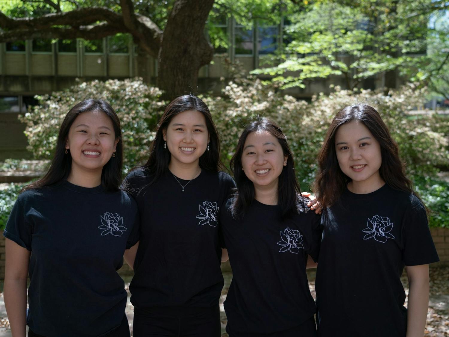 Seanna Chen, Katherine Zhang, Grace Chow, and Carina Lin (left to right) pose for a portrait in the Coker Arboretum on Friday, April 15, 2022. Chen, Zhang, Chow, and Lin are members of UNC's Flying Silk, a Chinese dance group that focuses on ribbon and fan dance.