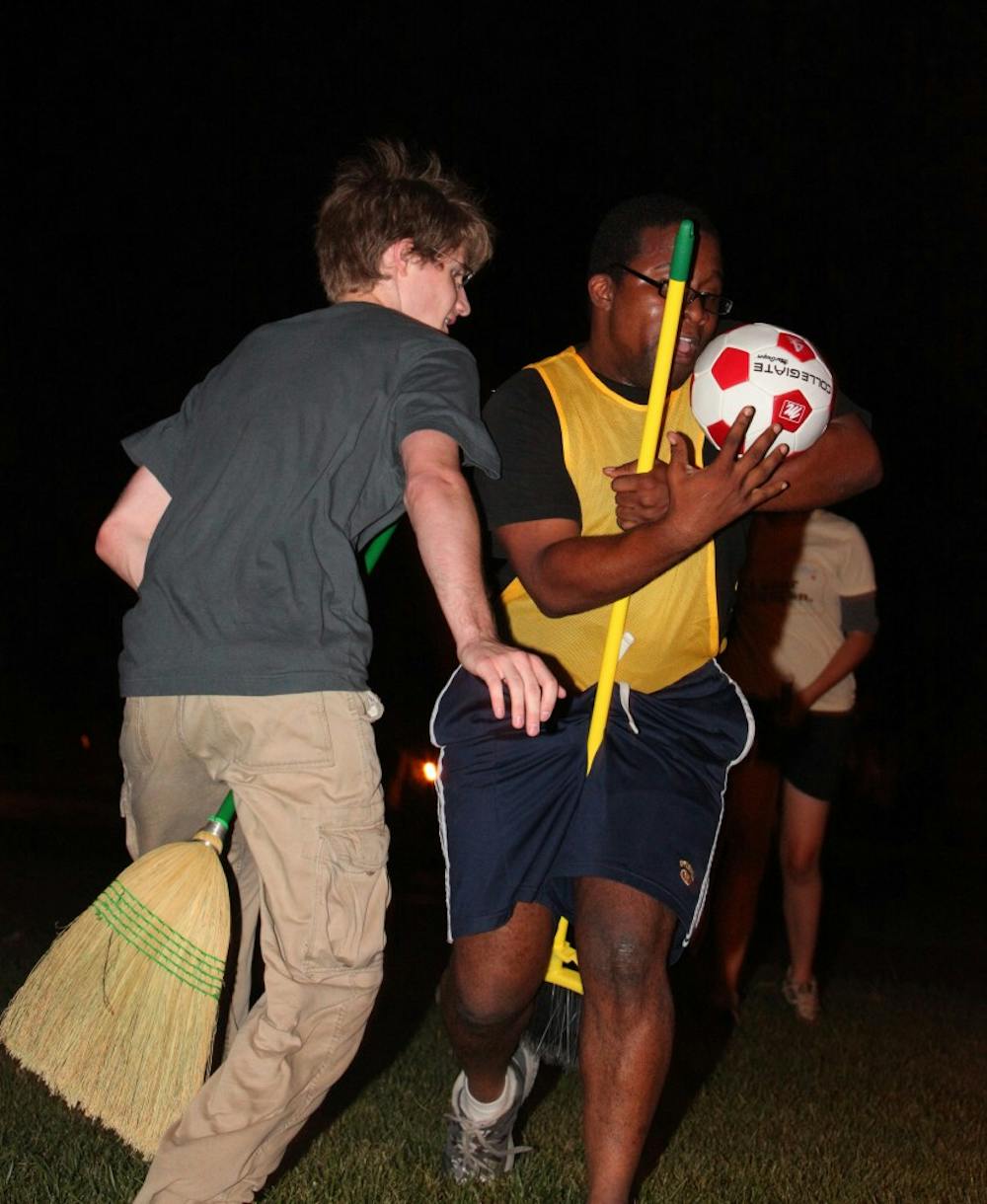 UNC senior Dave Matney (left) guards Stephone White from scoring during a practice for the Chapel Hill Quidditch team Monday night.