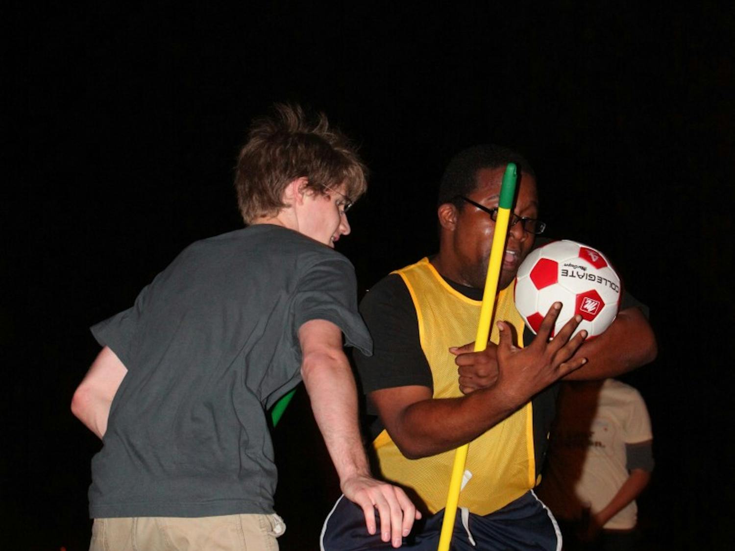 UNC senior Dave Matney (left) guards Stephone White from scoring during a practice for the Chapel Hill Quidditch team Monday night.