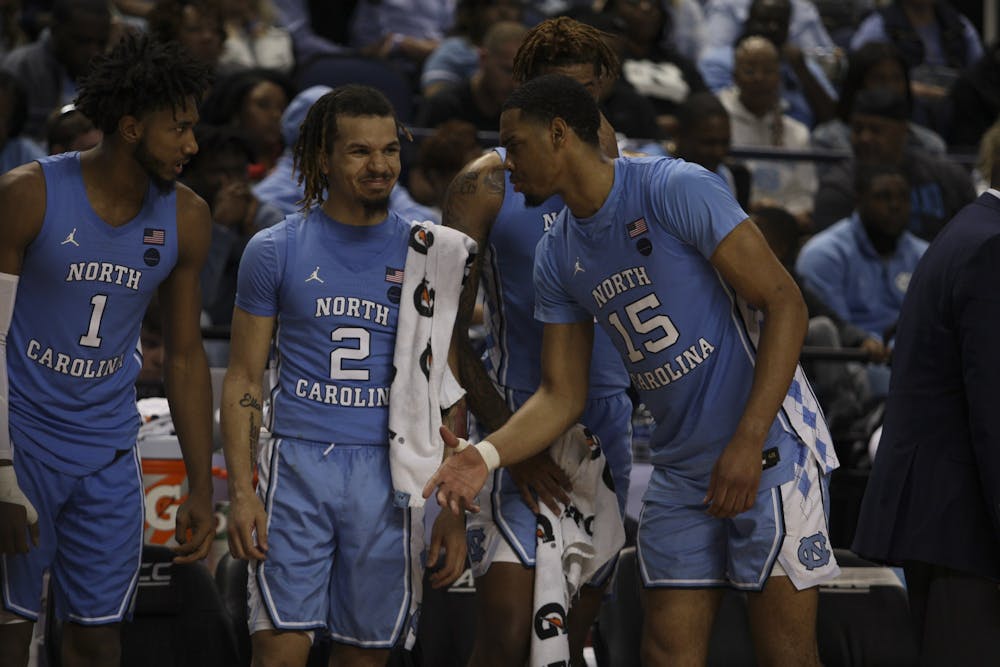 (From left) Sophomore guard Leaky Black (1), first-year guard Cole Anthony (2), and junior forward Garrison Brooks (15) goof around during the first-round game of the ACC tournament against Virginia Tech in the Greensboro Coliseum Complex on Tuesday, March 10, 2020. UNC beat Virginia Tech 78-56.