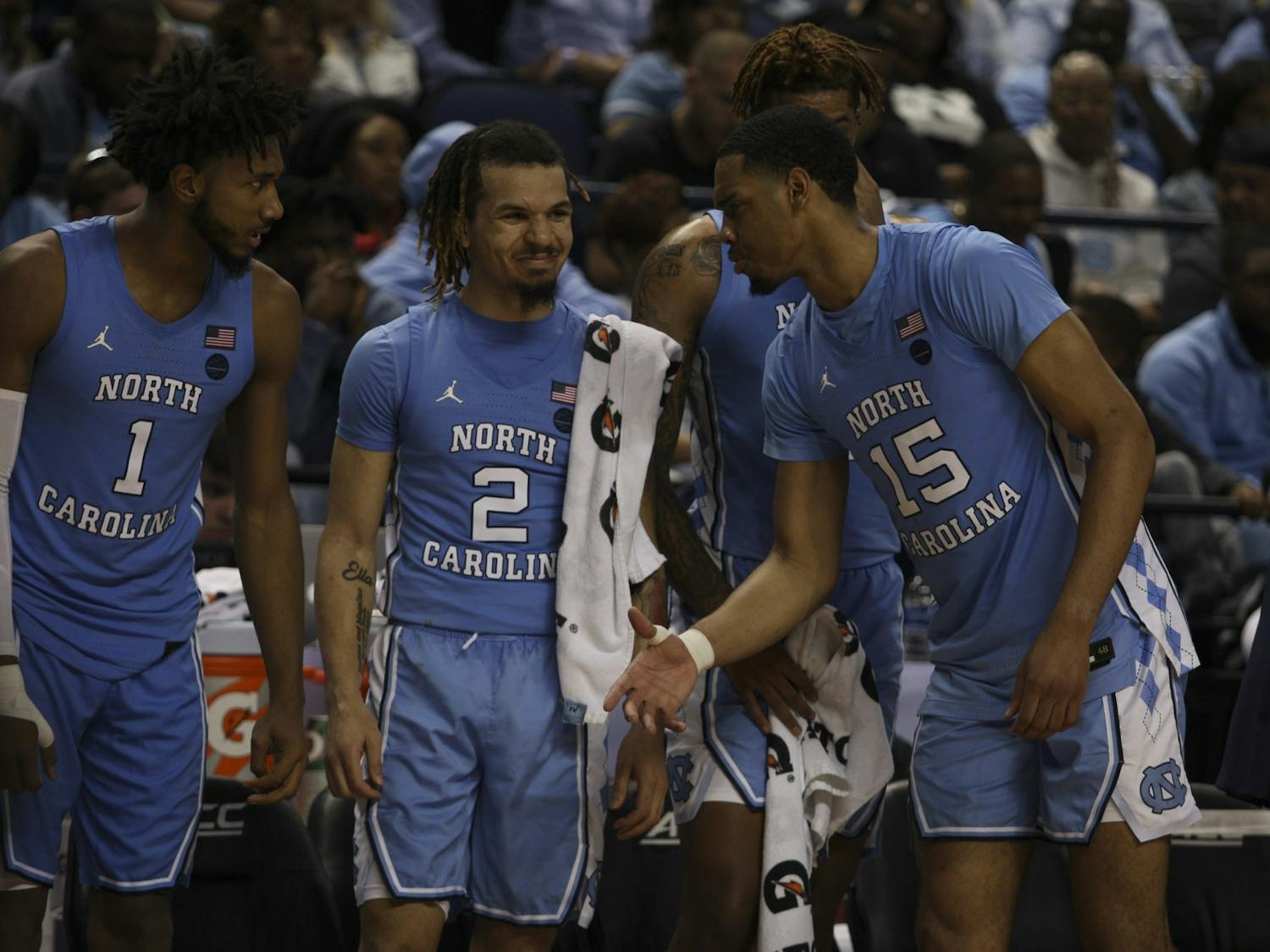 (From left) Sophomore guard Leaky Black (1), first-year guard Cole Anthony (2), and junior forward Garrison Brooks (15) goof around during the first-round game of the ACC tournament against Virginia Tech in the Greensboro Coliseum Complex on Tuesday, March 10, 2020. UNC beat Virginia Tech 78-56.