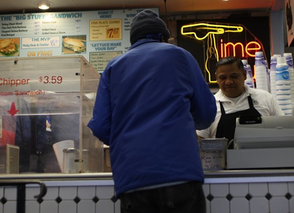 Alfonso Guzman checks out a customer at Time-Out restaurant. DTH/Shar-Narne Flowers