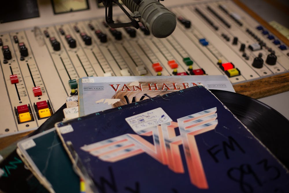 DTH Photo Illustration. A stack of Van Halen records sits on top of a mixing board.