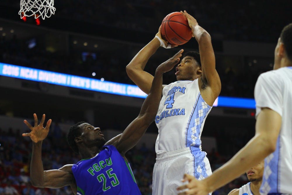 Isaiah Hicks shoots the ball over Marc0Eddy Norelia.&nbsp;