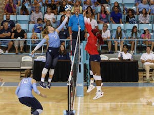 Sophomore outside hitter Mabrey Shaffmaster (9) goes to block a set from Arizona hitters over the net. UNC beat Arizona 3-2 at home on Saturday, Sept. 3, 2022.