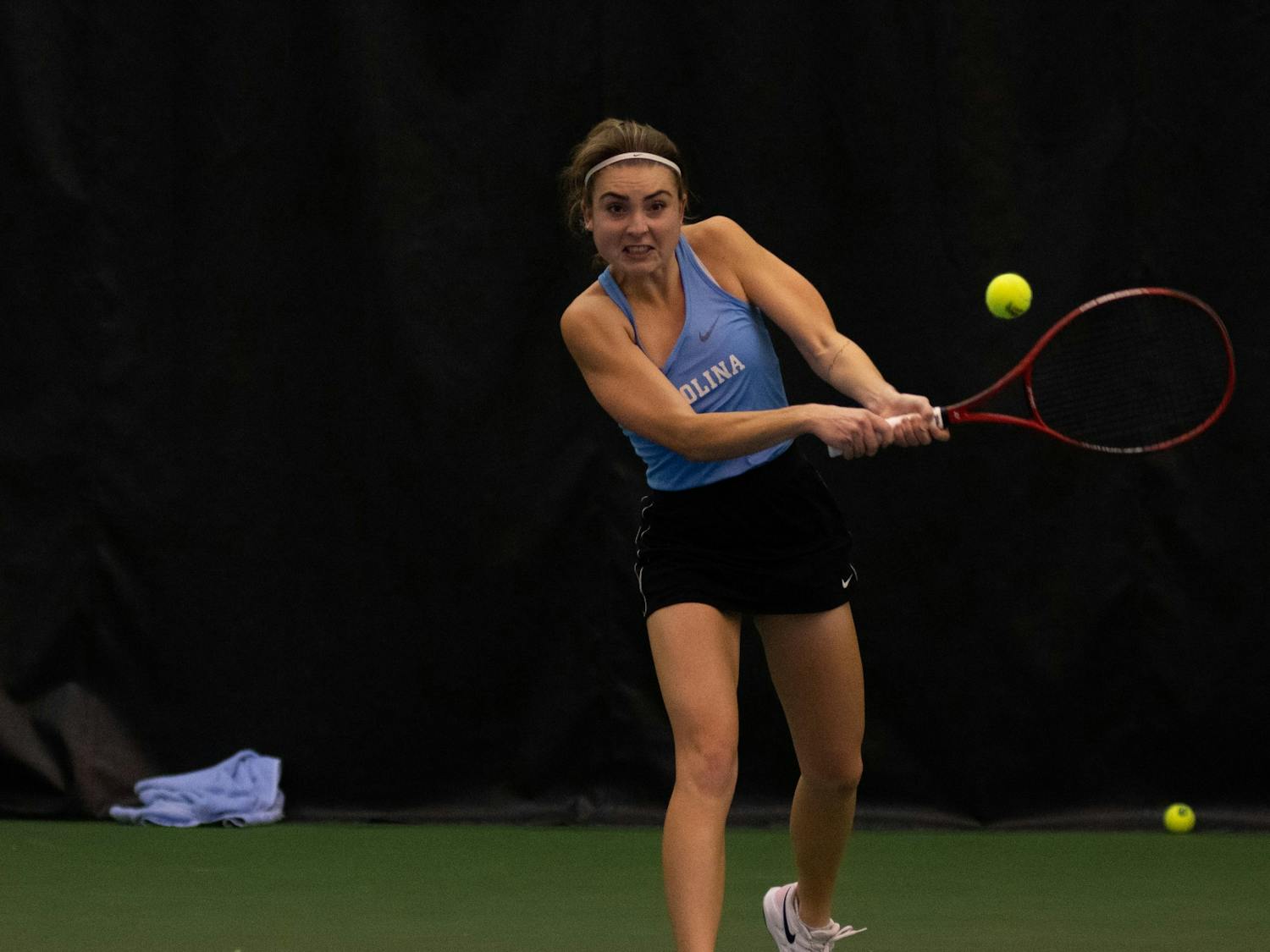 Fiona Crawley hits the ball during her singles match against Elon University's Lizette Reding on Saturday, Jan. 15, 2022, in Chapel Hill, NC.