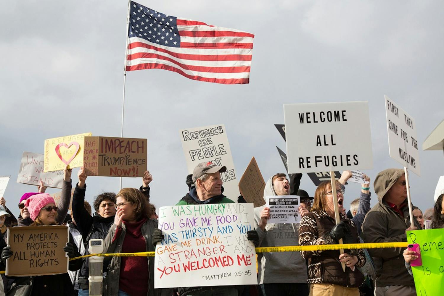 Protesters gather outside terminal two at RDU Airport Sunday in response to President Donald Trump's executive order banning immigrants from certain countries from entering the U.S.