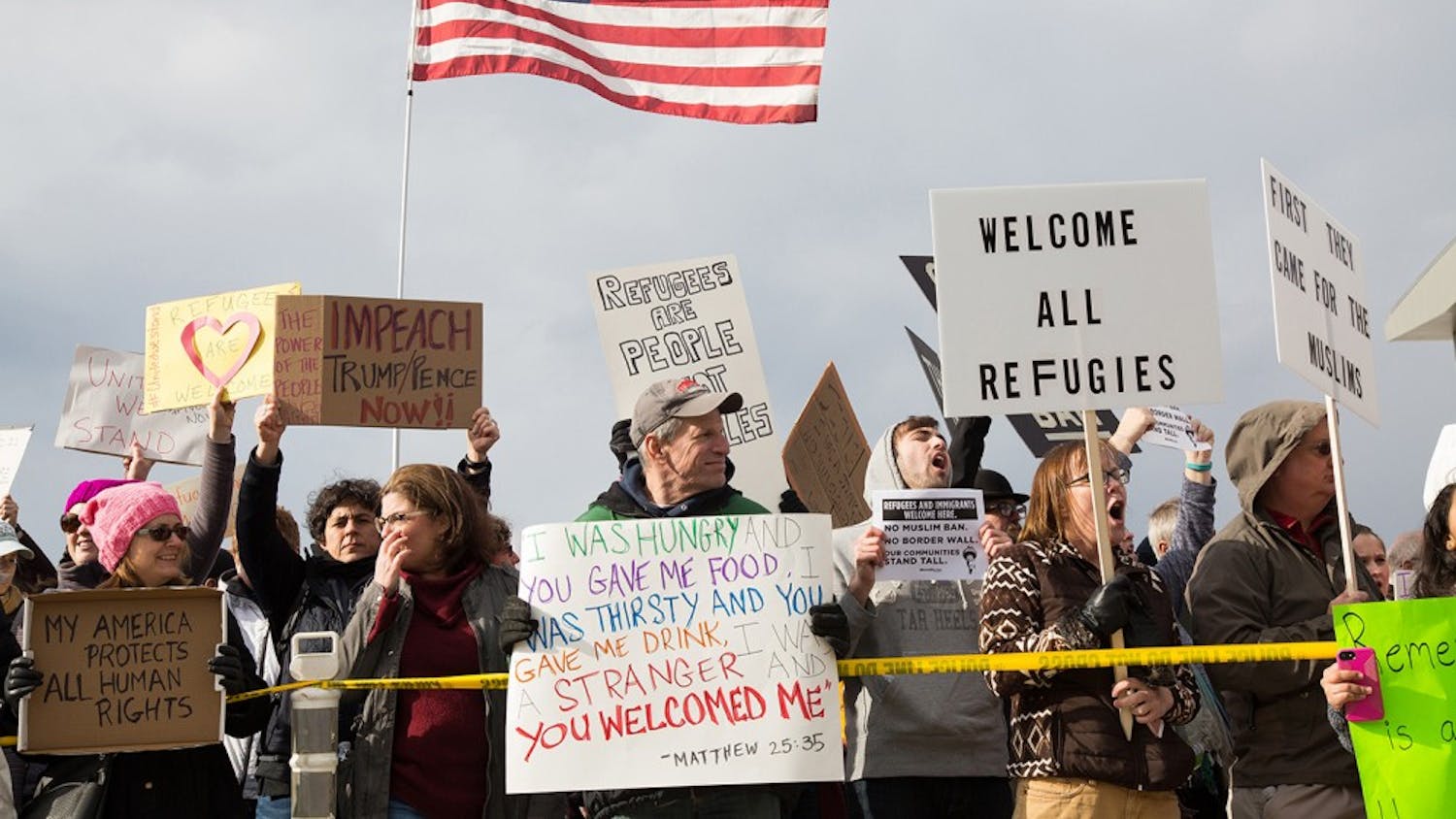 Protesters gather outside terminal two at RDU Airport Sunday in response to President Donald Trump's executive order banning immigrants from certain countries from entering the U.S.