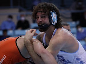 Austin O'Connor, defending national champion, is caught in the moment as he wins his match against a Campbell opponent. The Tar Heels beat Campbell 24-12 in Carmichael Arena on Nov. 21.
