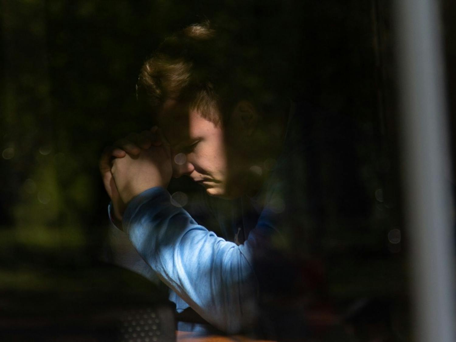 Austin Kliewer, junior exercise and sports science major, prays during UNC week of 24/7 prayer at the North Carolina Study Center, April 16, 2019. UNC week of 24/7 prayer began on April 10 and ends on April 17 and students sign up for timeslots to pray with a stranger. This was Kliewer's first time participating in the event. "Just praying in general for everyone on campus - both believers and non-believers - I think is one of the most powerful things you can do is just talk to the creater of the world, going on their behalf is just amazing," Kliewer said.