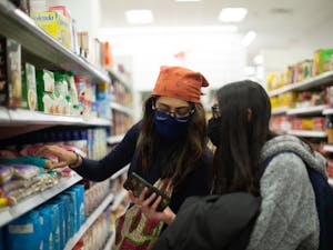 Juniors Pareen Bhagat (left) and Disha Dhamani (right) shop for food at the Target on Franklin Street on Friday, March 19, 2021.