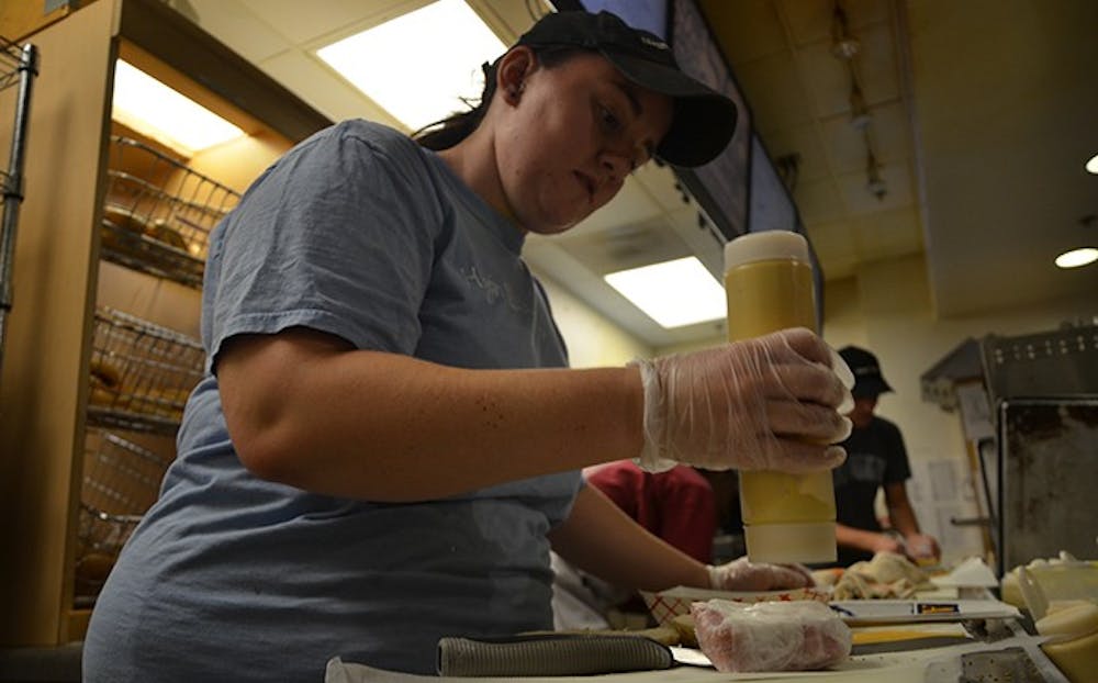 	Senior Rachel Gaylord-Miles prepares food for a customer. Gaylord-Miles is one of six students working at Alpine Bagel Cafe. 