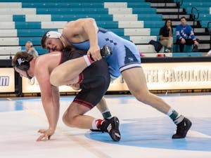 Cory Daniel (right) and David Jensen compete in the heavyweight match during the home wrestling match vs. Nebraska on Saturday, Dec. 15 2018.