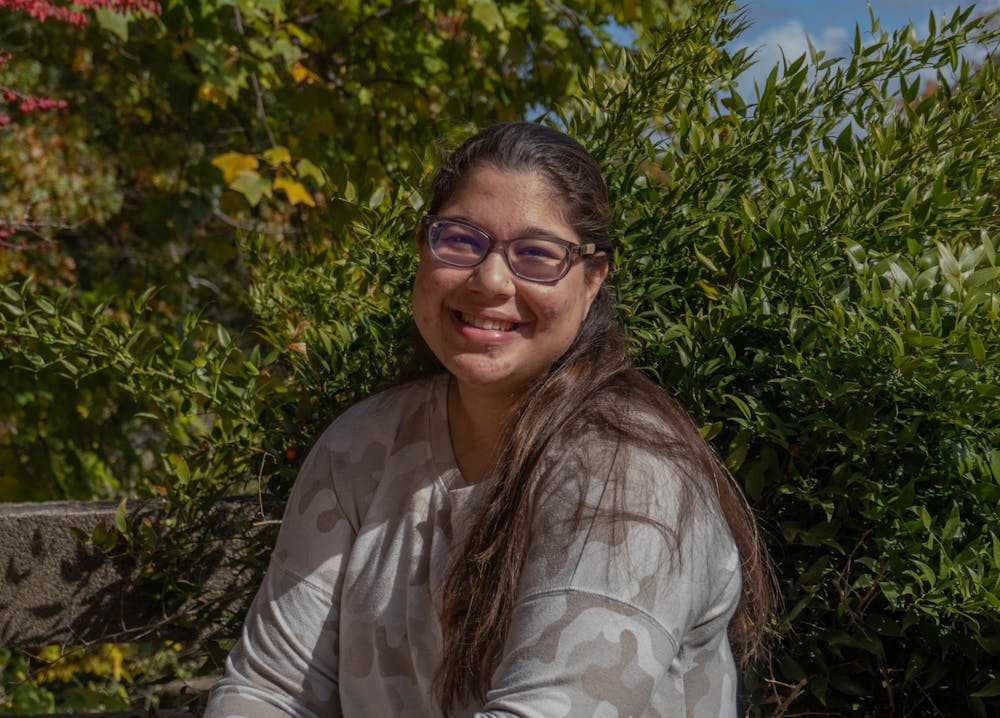 <p>Vanya Bhat, a junior majoring in neuroscience and medical anthropology, poses for a portrait on Nov. 11 outside of Davie Hall. Mental health is especially stigmatized in Asian American communities, Bhat said.</p>