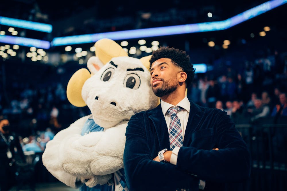 <p>ACC Network Analyst and former Tar Heel KJ Smith poses with Rameses at the ACC Men's Basketball Tournament on March 11, 2022 at the Barclays Center. Photo courtesy of Jeff Armstrong.</p>