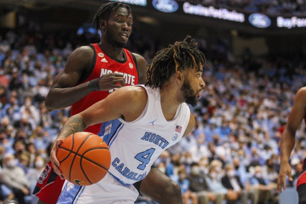 <p>UNC sophomore guard RJ Davis (4) runs with the ball at the game against North Carolina State University on Saturday Jan. 29, 2022 at the Smith Center in Chapel Hill. UNC won 100-80.</p>