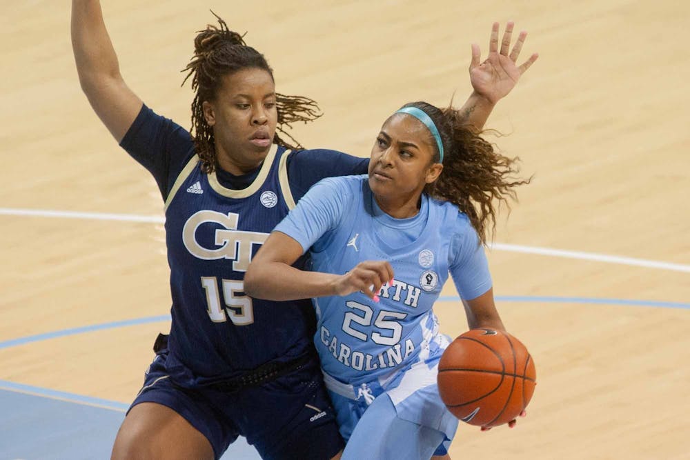 UNC first year guard Deja Kelly (25) dribbles the ball during the Tar Heels 89-59 win against Georgia Tech on Thursday, Feb. 25, 2021 at Carmichael Arena in Chapel Hill, NC.