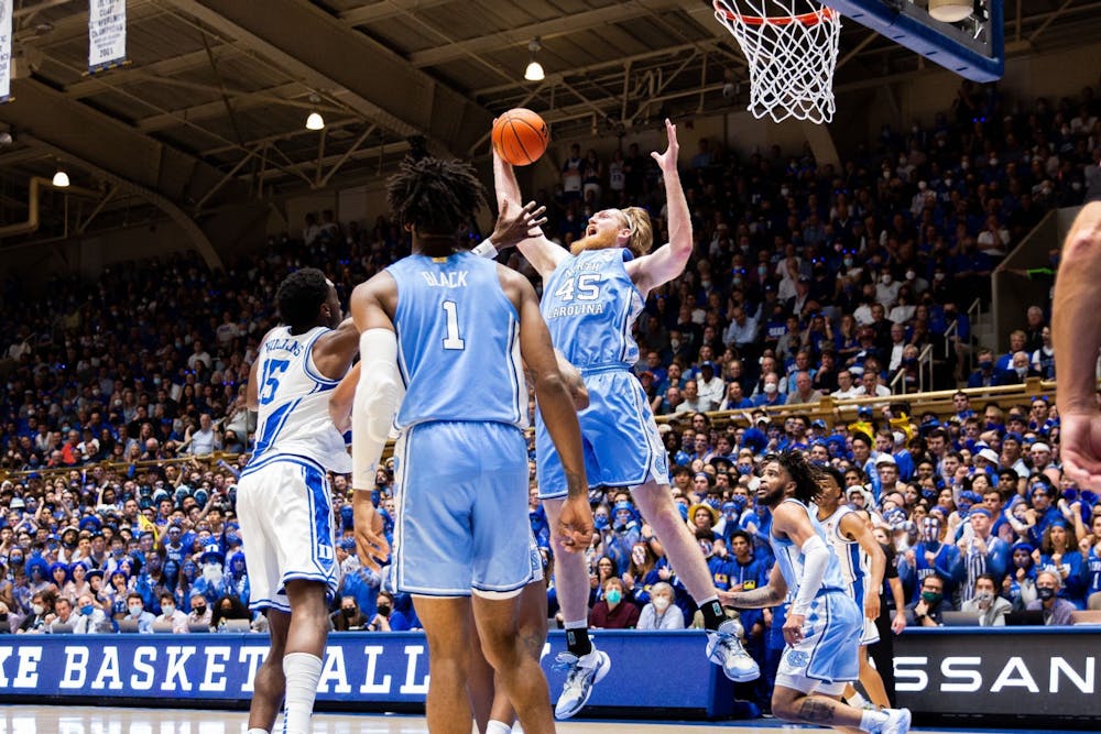 <p>Graduate forward Brady Manek reaches to grab the ball in the game against Duke on March 5, 2022.</p>