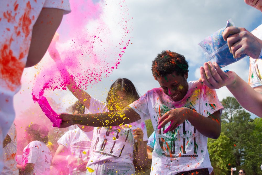 <p>UNC students participate in Holi Moli, an annual event held by students to celebrate Holi, on Saturday, April 23, 2022.</p>