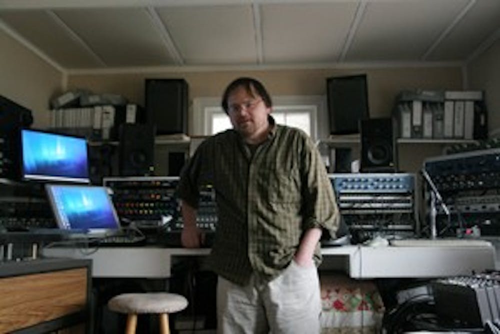 Mebane producer Jerry Kee stands in front of the equipment in his living room.