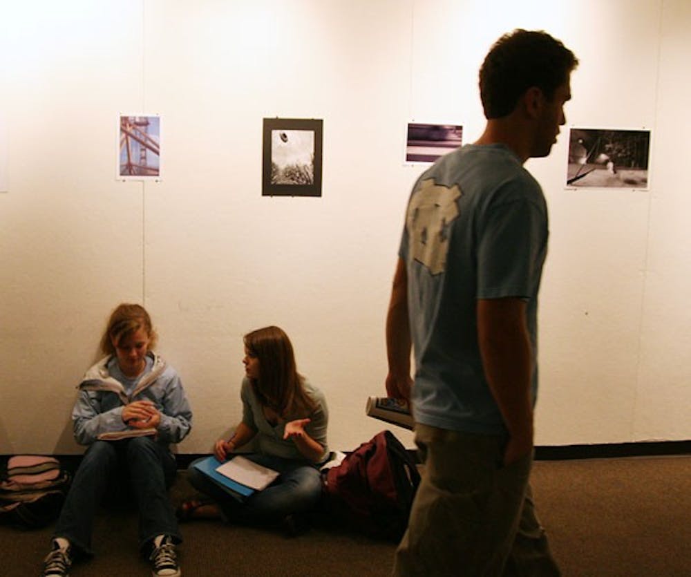 Students study Sunday night under the current art exhibit in the Student Union gallery. DTH/Jessey Dearing