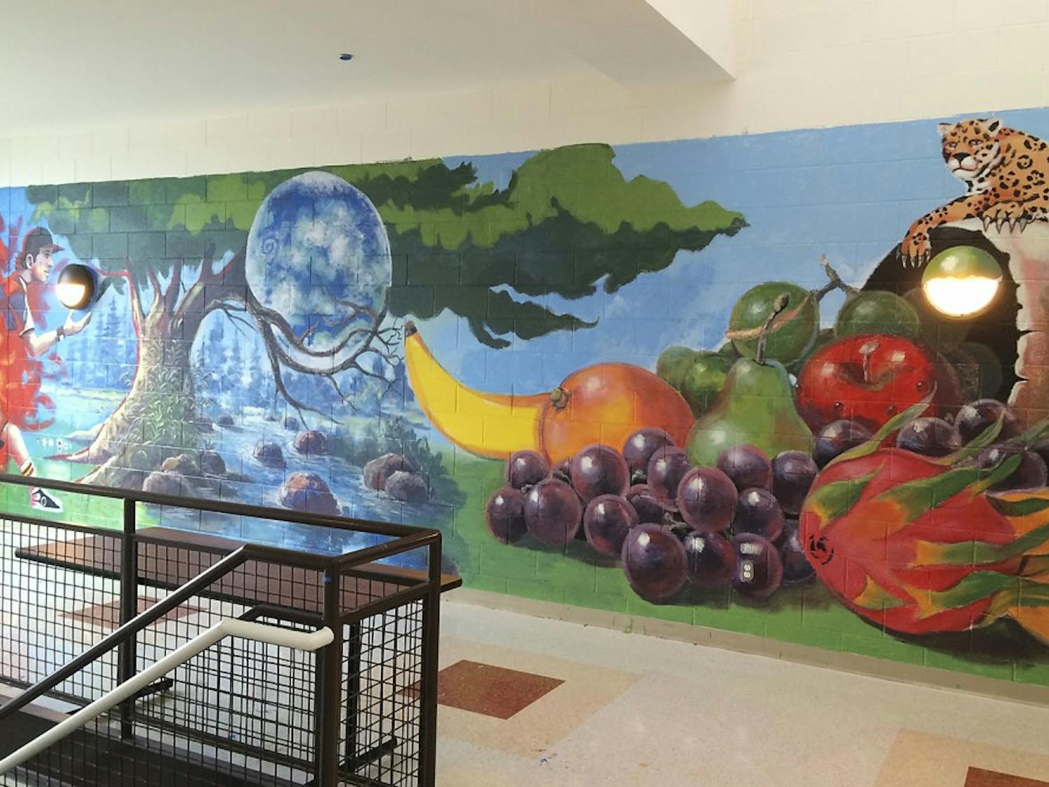 Muralists Carlos Veras and Anthony Vasquez created two symbolic murals in Carrboro High School. Photo courtesy of Chapel Hill-Carrboro City School. 