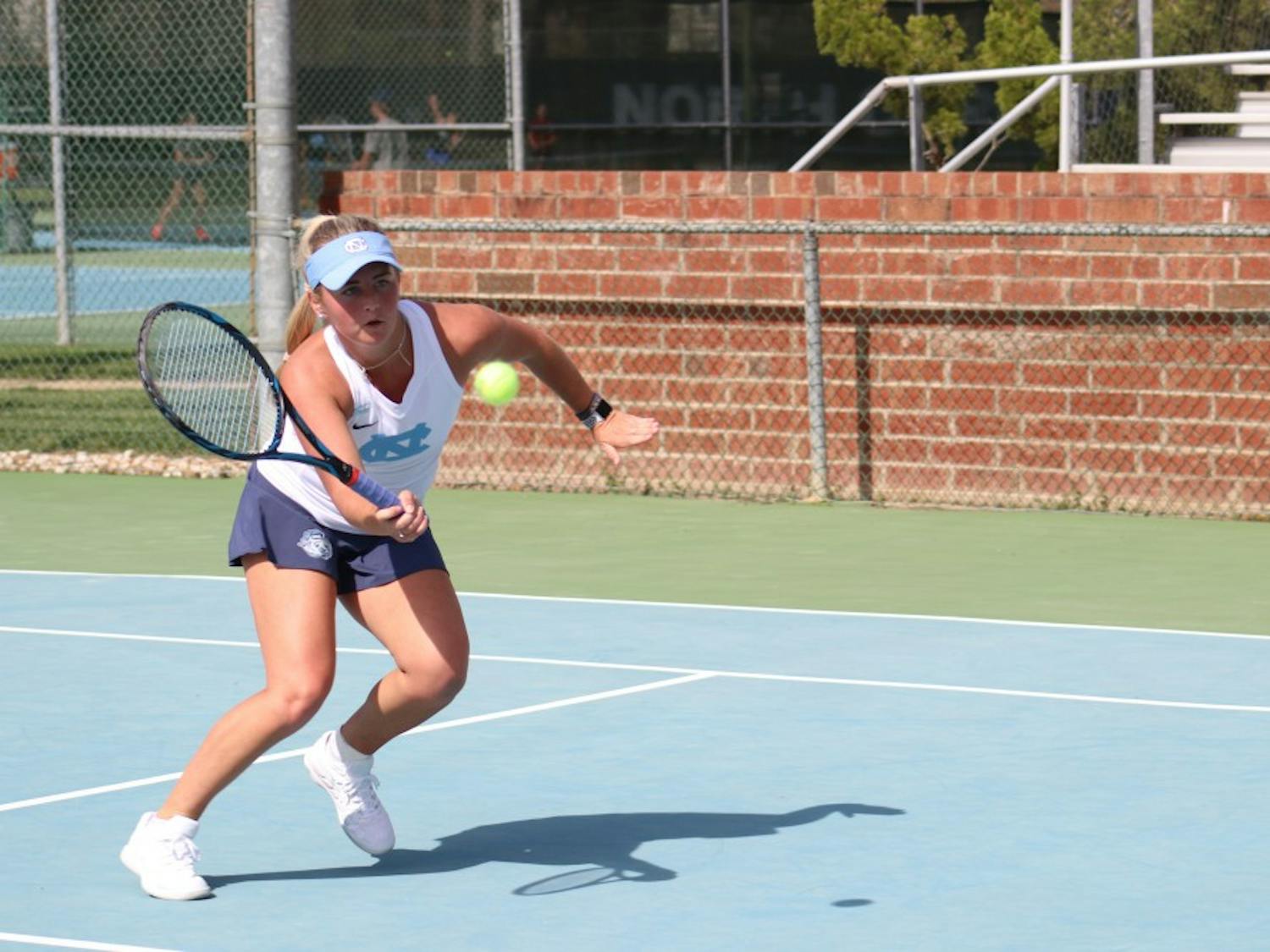 Makenna Jones hits a volley against Virginia on April 13 at the Cone-Kenfield Tennis Center.