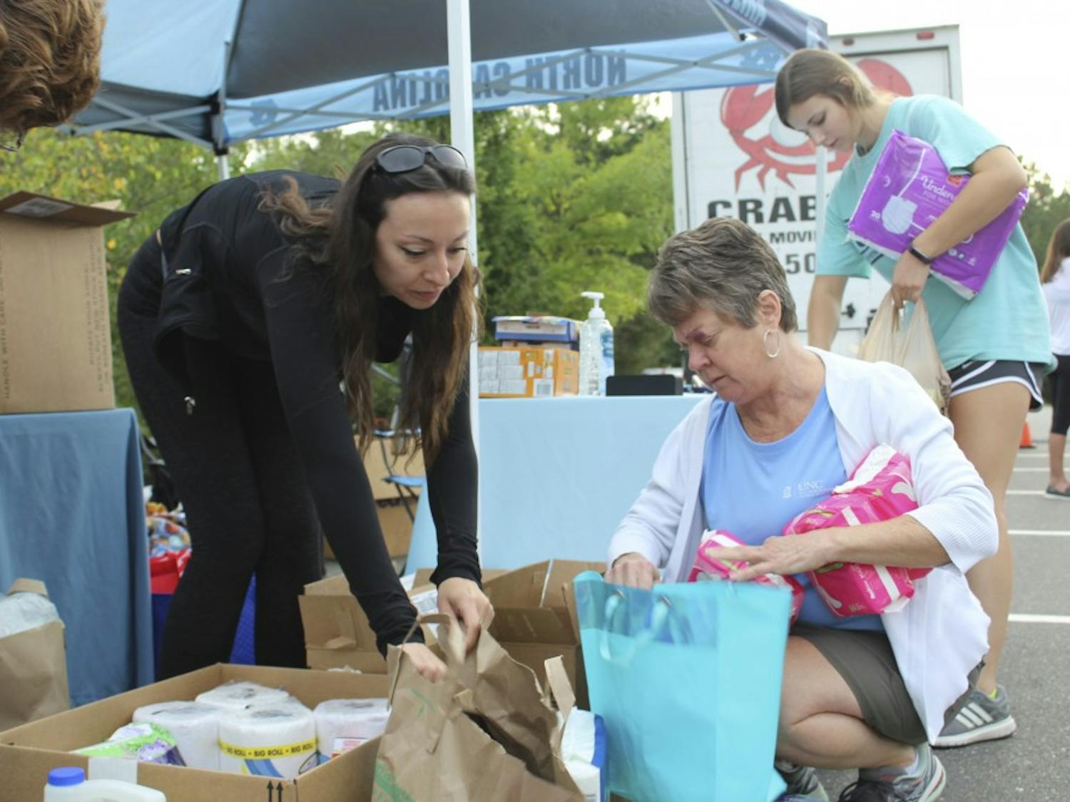 (From left to right) Jed Higdon, Luisa Brooks, Michele Fulton and Jessica Bevard sort donated items at the "Fill the Truck" relief drive for Hurricane Florence early Tuesday morning on Oct. 9, 2018. 