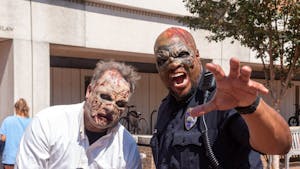 Zombies pose outside of Greenlaw Hall during the Tar Heel Zombie Preparedess Festival on Thursday, Sept. 22, 2022.