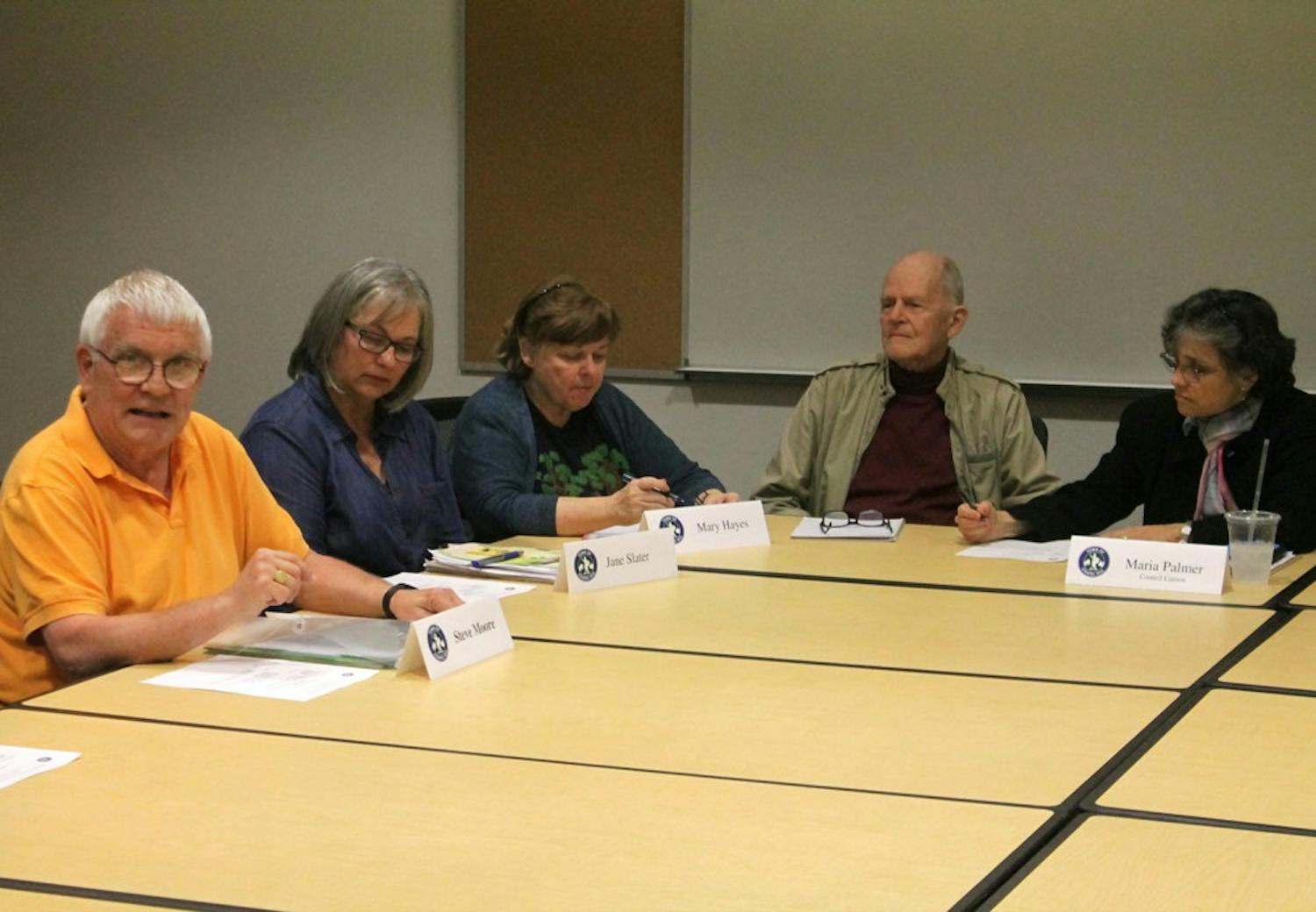 (Left) Steve Moore, Jane Slater, Mary Hayes, Sanley Peele, and Maria Palmer discuss a removed memorial during the Cemetery Advisory Board Meeting Wednesday.