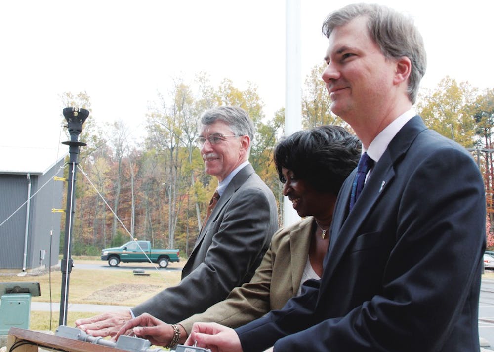 Rep. Joe Hackney, Valerie Foushee and Holden Thorp prepare to light a symbolic flare Monday marking the start of a joint project between UNC and Orange County to convert methane gas into electricity.