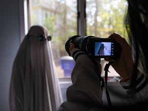 DTH Photo Illustration. Many students have been taking part in various TikTok trends, such as ghost photoshoots or wearing wigs.