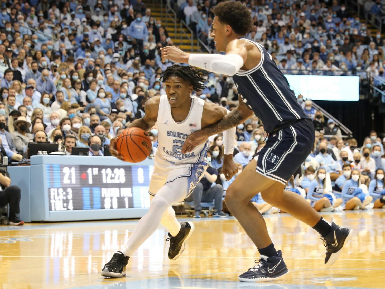 UNC sophomore guard Caleb Love (2) drives past a Duke opponent during a UNC men's basketball game against Duke in the Dean Smith Center on Saturday, Feb. 5, 2022. Duke won 87-67.