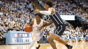 UNC sophomore guard Caleb Love (2) drives past a Duke opponent during a UNC men's basketball game against Duke in the Dean Smith Center on Saturday, Feb. 5, 2022. Duke won 87-67.