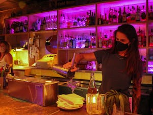 Orange County Social Club bartender Laura King serves drinks on July 25, 2022.
