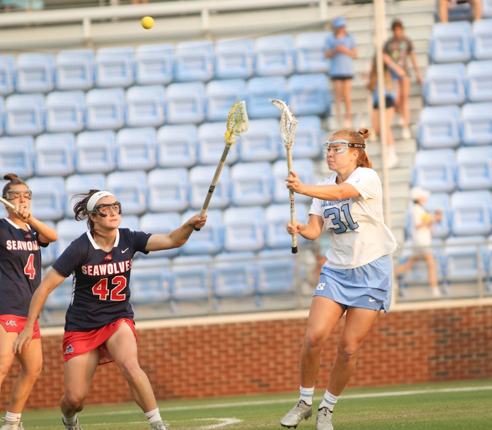Graduate attacker Andie Aldave (31) passes the ball through Stony Brook defenders. UNC won 8-5 against Stony Brook at home in the NCAA Quarterfinals on Thursday, May 19, 2022.