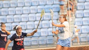 Graduate attacker Andie Aldave (31) passes the ball through Stony Brook defenders. UNC won 8-5 against Stony Brook at home in the NCAA Quarterfinals on Thursday, May 19, 2022.