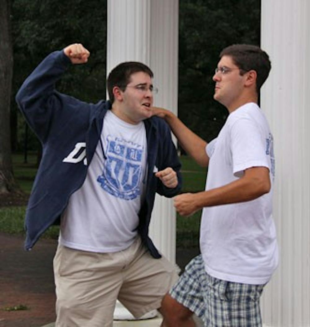 Alex Klein, left, and Mike Santangelo, long-time best friends, illustrate their allegiances to their opposing alma maters.