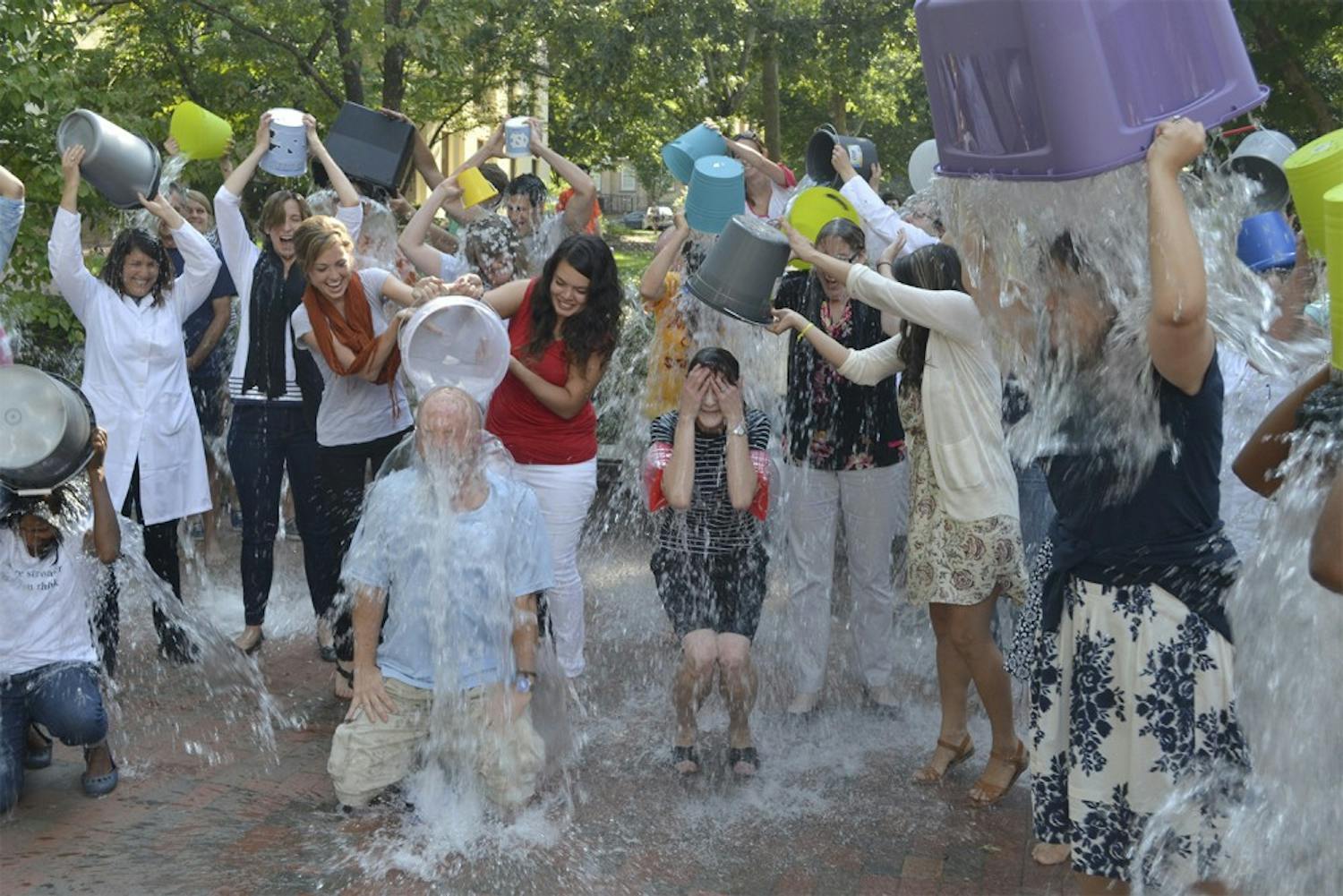 Individuals come together Wednesday afternoon outside of Davie Hall to complete the ALS ice bucket challenge in honor of a psychology professor who was recently diagnosed with ALS.