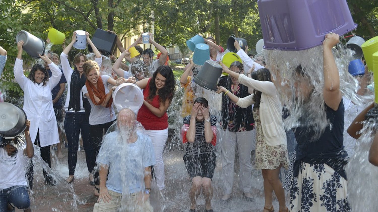 Individuals come together Wednesday afternoon outside of Davie Hall to complete the ALS ice bucket challenge in honor of a psychology professor who was recently diagnosed with ALS.
