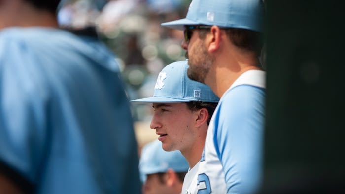 UNC freshman infielder and right-handed pitcher Justin Szestowicki (14) watching his team play from the sideline during a baseball game against Georgia Tech on Saturday, April 16, 2022, at Boshamer Stadium. UNC won 10-5.