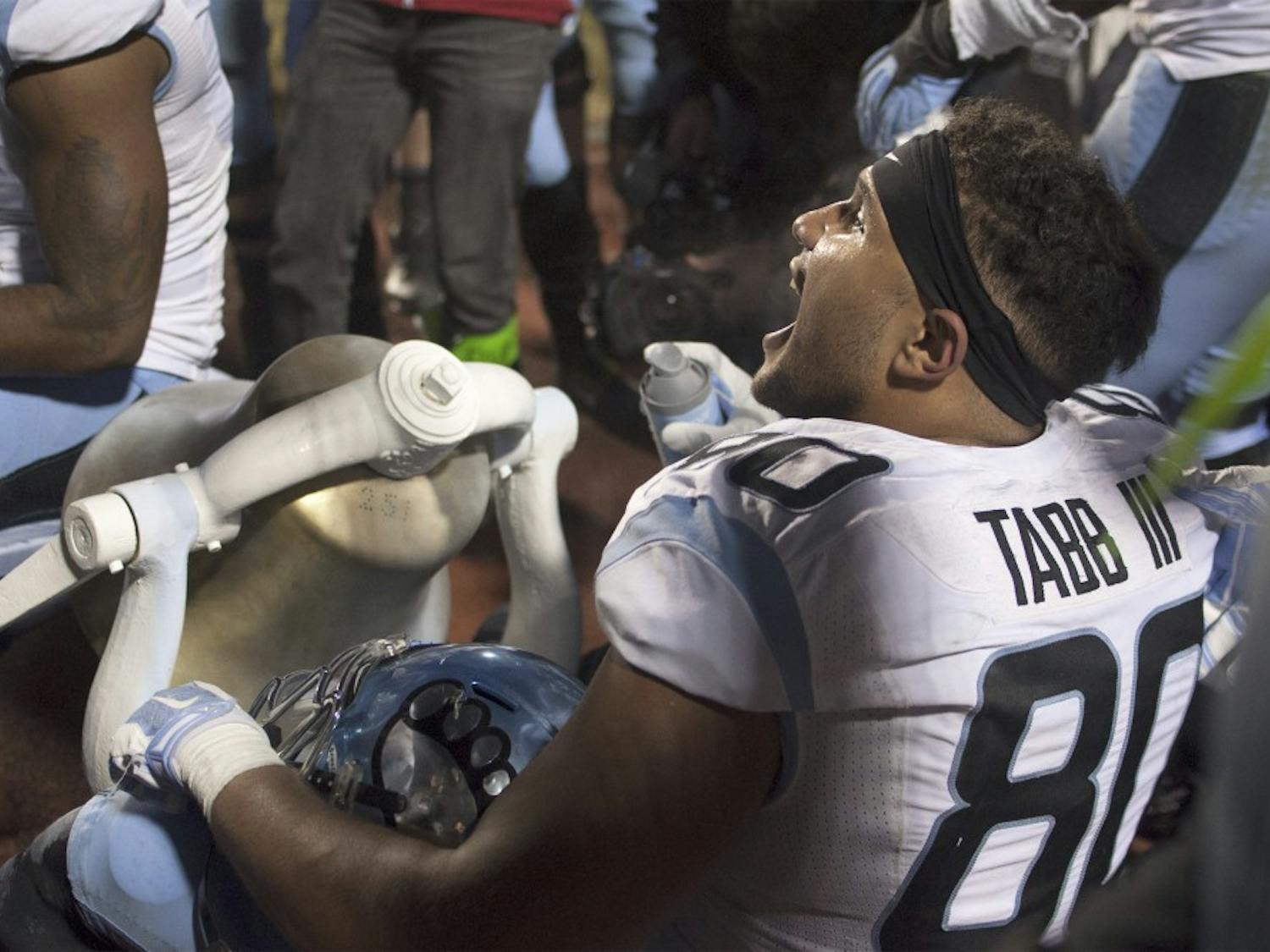 Jack Tabb celebrates with the rest of the Tar Heel football team as they take home the Victory Bell after defeating Duke in 2014.