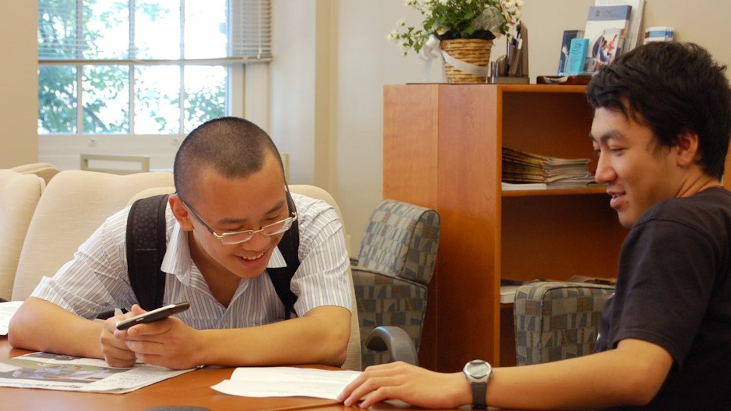 Zhe Wang (left) and Yadong Goo, both sophomores from China, review each other’s resumes while waiting for a University Career Services counselor to call them into their meeting during the Resume Marathon. 