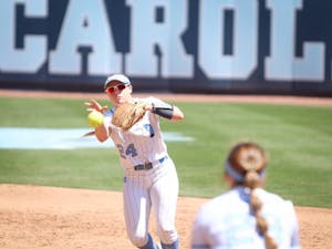 Shortstop Skyler Brooks (24) passes the ball to first base to get a Florida State hitter out. UNC lost to Florida State 2-9 at home on Sunday, April 17, 2022.